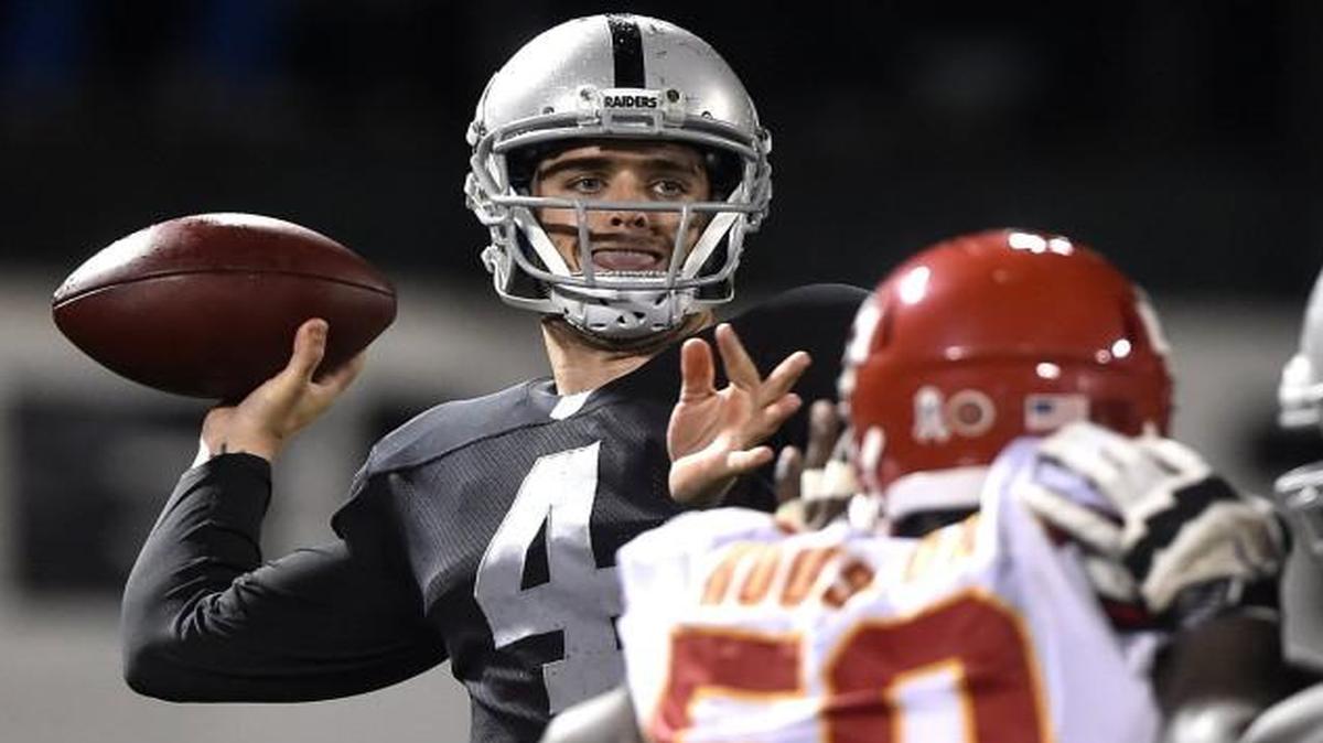 Oakland Raiders quarterback Derek Carr was rushed by Kansas City Chiefs outside linebacker Justin Houston during a 2014 game.
