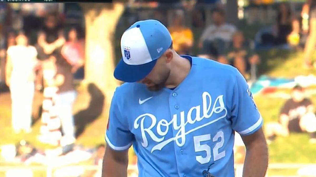 Royals starter Michael Wacha took care of his chain, then threw a pitch.