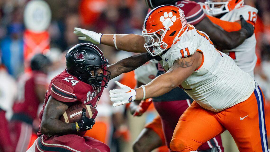 Peter Woods of the Clemson Tigers tackles South Carolina’s Mario Anderson during their game at Williams-Brice Stadium on Nov. 25, 2023 in Columbia, South Carolina.