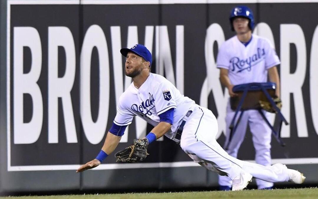 Kansas City Royals left fielder Alex Gordon keeps his eye on the ball as he prepared to make a diving catch in foul territory during a 2016 game at Kauffman Stadium.