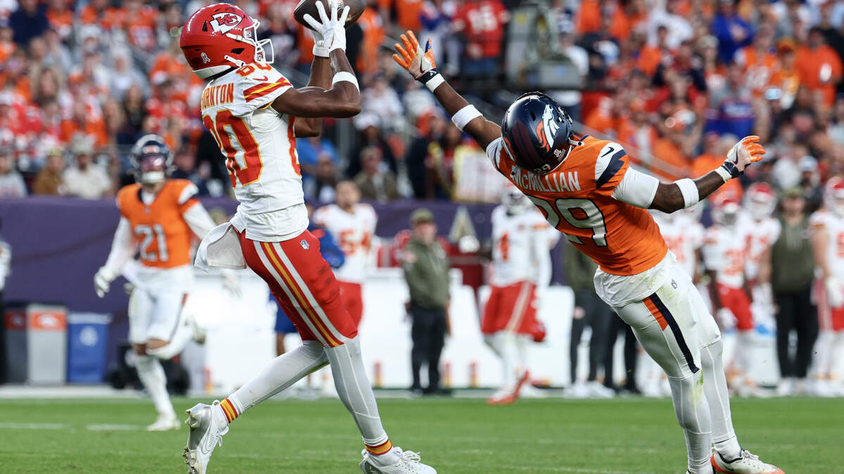 The Chiefs’ Tyquan Thornton hauls in a pass while defended by Ja'Quan McMillian of the Denver Broncos during the third quarter at Empower Field At Mile High on Nov. 16, 2025 in Denver, Colorado.