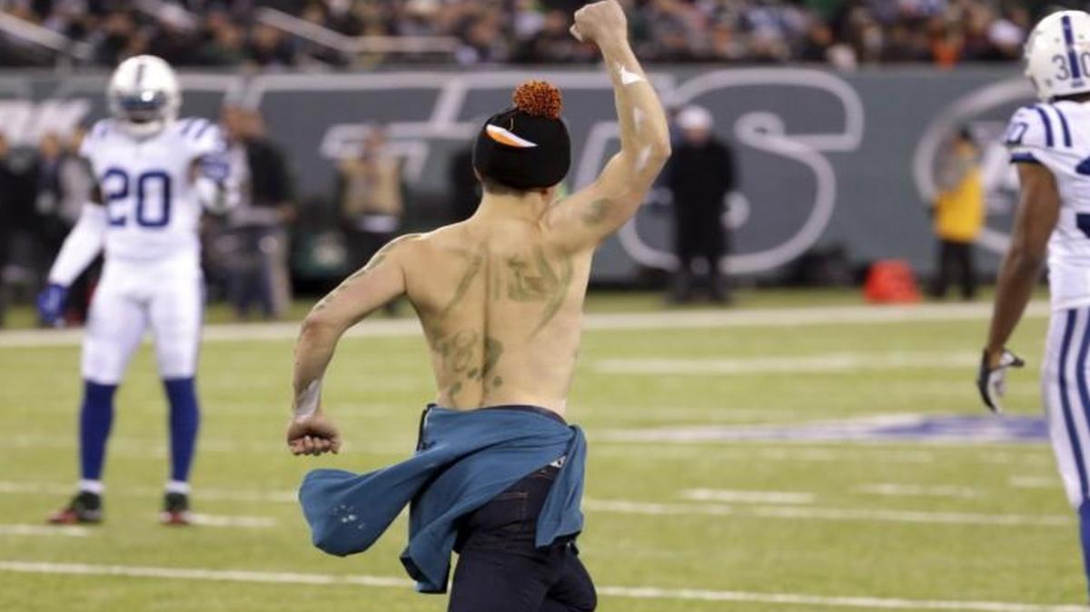 A person runs onto the field during the second half of Monday’s game between the New York Jets and the Indianapolis Colts in East Rutherford, N.J.