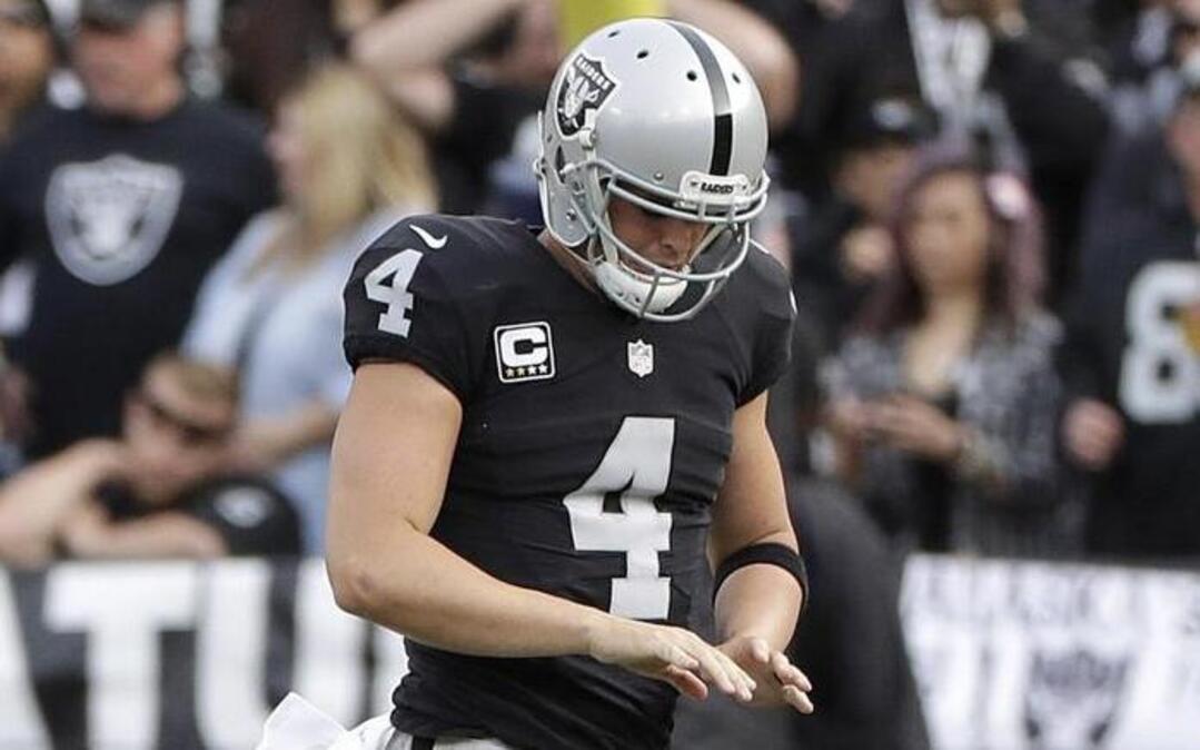 Oakland Raiders quarterback Derek Carr ran off the field after an injury to his hand.
