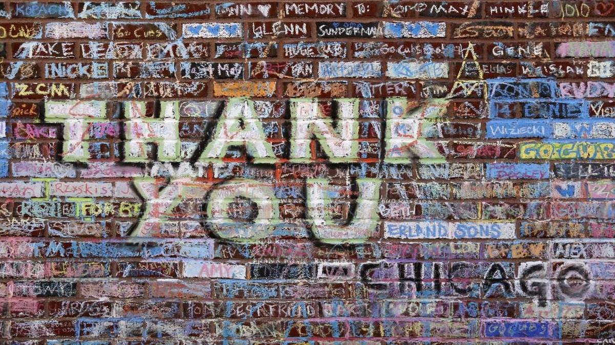 Messages in support of the Chicago Cubs’ championship run and in remembrance of friends and family who never saw the Cubs win the World Series, were written and drawn in chalk on an outer wall at Wrigley Field.