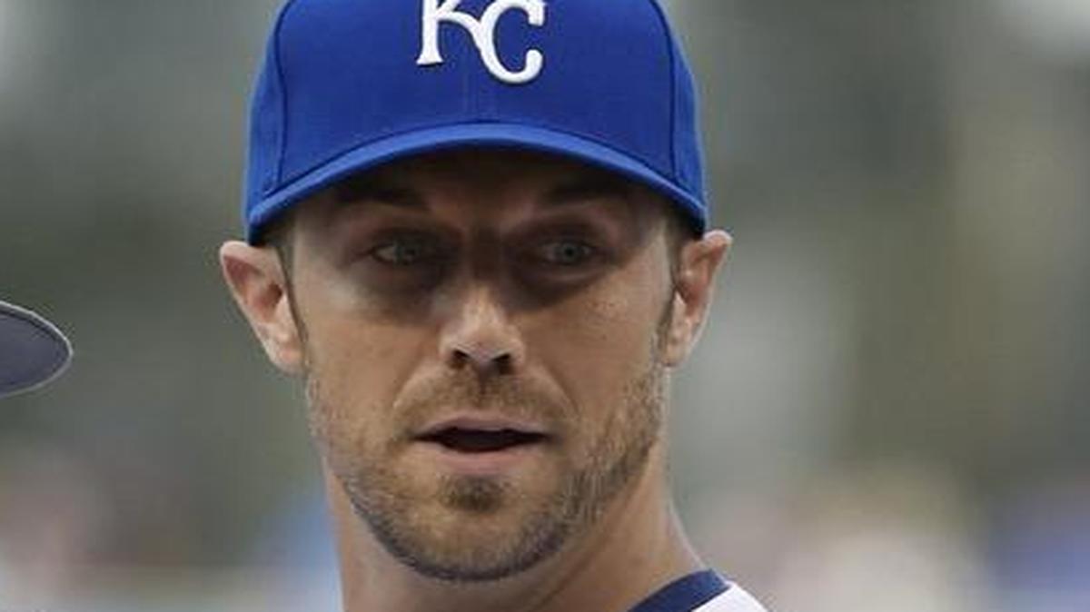 Kansas City Chiefs quarterback Alex Smith holds his son Hudson as he throws out a first pitch before Friday’s baseball game between the Kansas City Royals and New York Yankees on June 6, 2014 at Kauffman Stadium.
