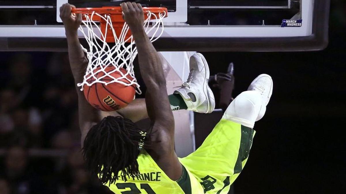 In a happier moment, Baylor forward Taurean Prince held the rim after a dunk against Yale. However, Prince was charged with a technical foul on the play.
