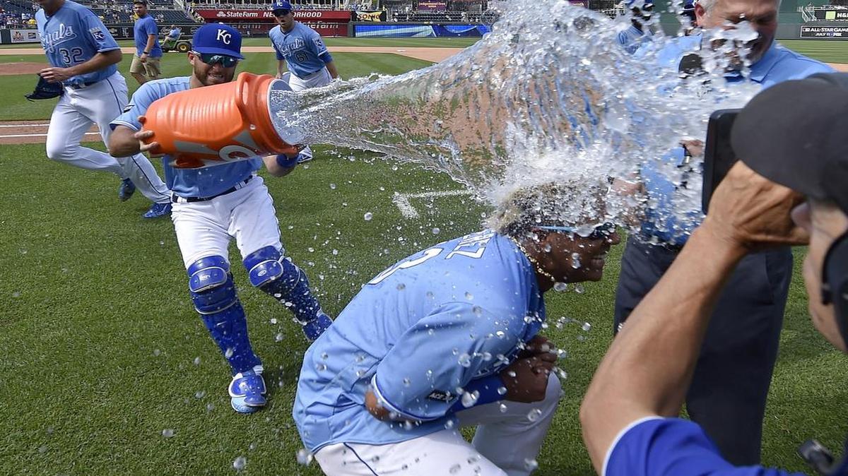 Salvador Perez ducked under a victory shower from Drew Butera after Perez’s grand slam helped the Royals to a 6-4 victory over the Boston Red Sox on Wednesday at Kauffman Stadium.