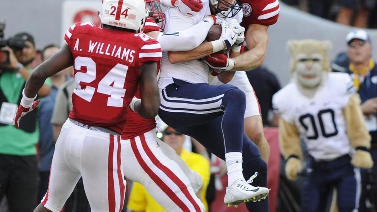 
BYU wide receiver Mitch Mathews caught the game-winning touchdown between Nebraska defensive back Aaron Williams (24) and safety Nate Gerry as time ran out in Saturday’s game.
