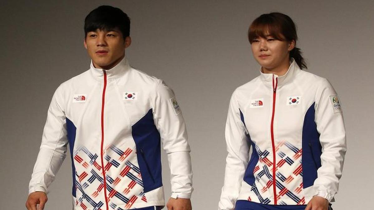 South Korean Olympic wrestling athlete Kim Hyeon-woo (left) and handball athlete Kim On-a (right) present the South Korean Olympic team uniforms for the medal ceremony of the 2016 Rio de Janeiro Olympic Games.