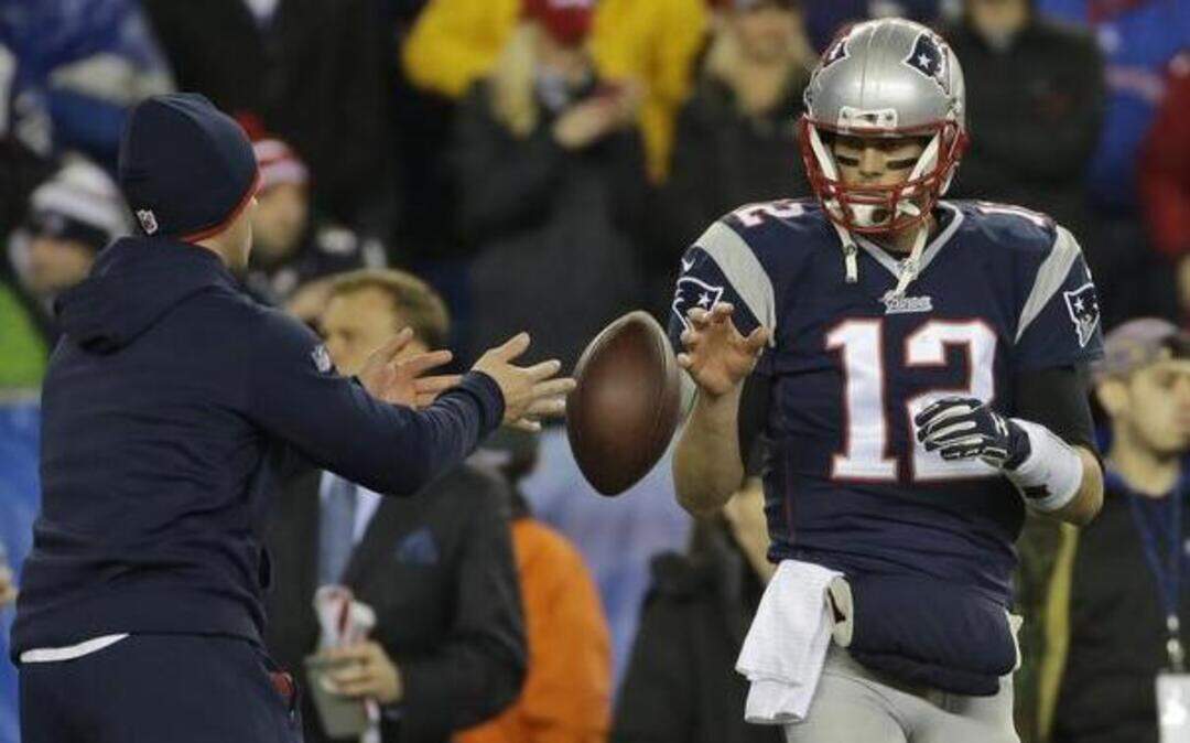 
New England Patriots quarterback Tom Brady had a ball tossed to him during warmups before the AFC Championship Game against the Indianapolis Colts in Foxborough, Mass. The NFL says its investigation into whether the New England Patriots used underinflated footballs in the game.

