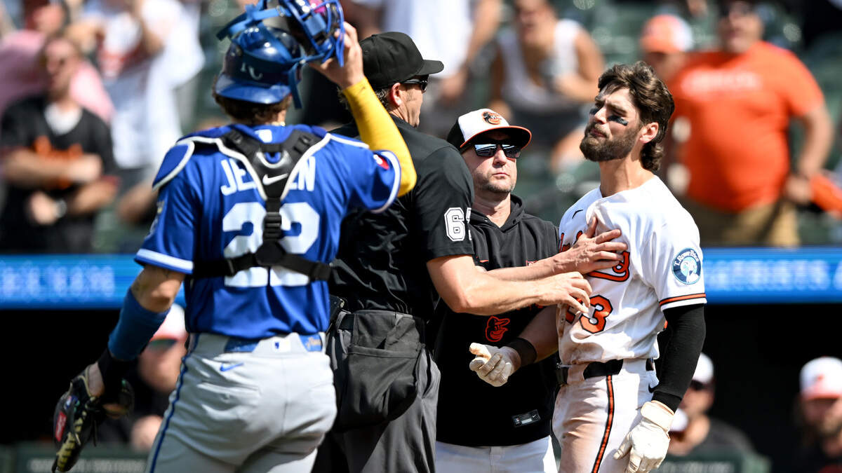 Blaze Alexander #23 of the Baltimore Orioles is held back by manager Craig Albernaz #55 and home plate umpire Ryan Additon after being hit by a pitch in the seventh inning against the Kansas City Royals at Oriole Park at Camden Yards on Sunday July 12, 2026 in Baltimore, Maryland.