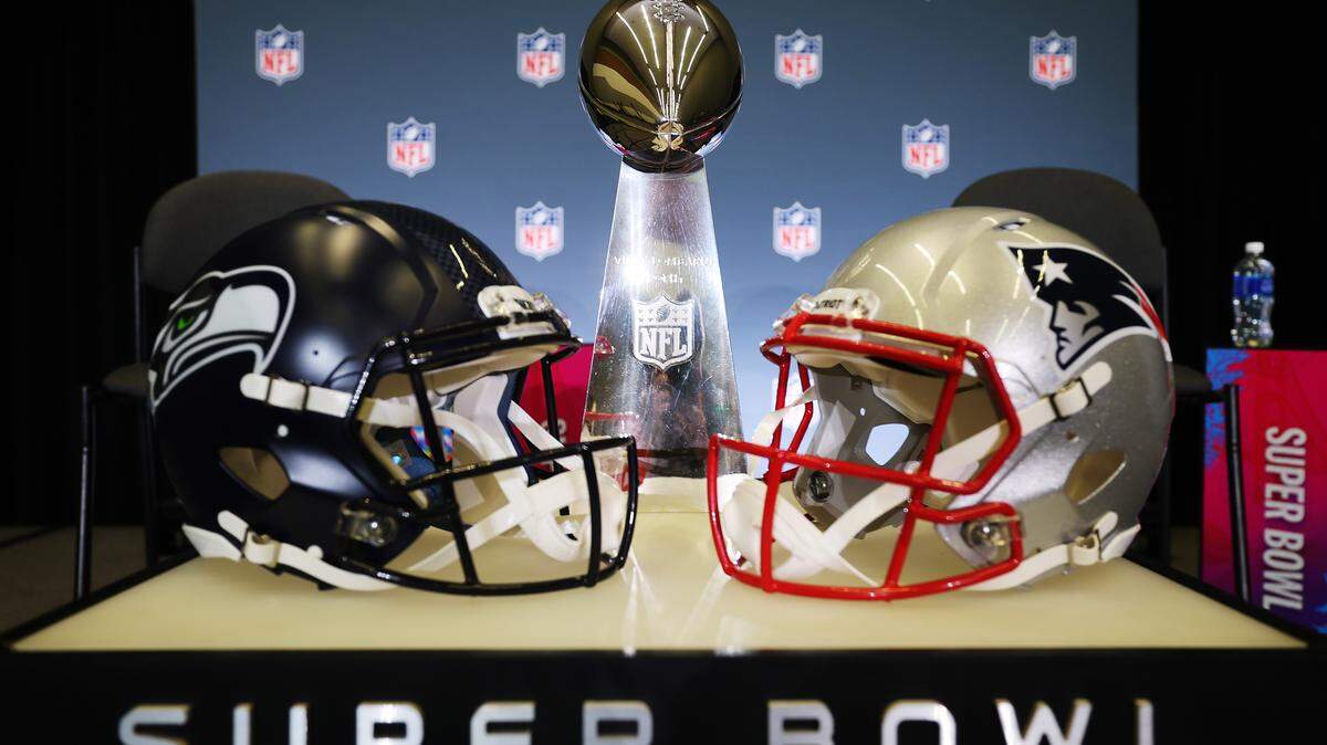 The Vince Lombardi Trophy is framed by the Seattle Seahawks and New England Patriots helmets during Super Bowl LX Opening Night at San Jose McEnery Convention Center on Feb. 2, 2026 in San Jose, California. (Photo by Chris Graythen/Getty Images)