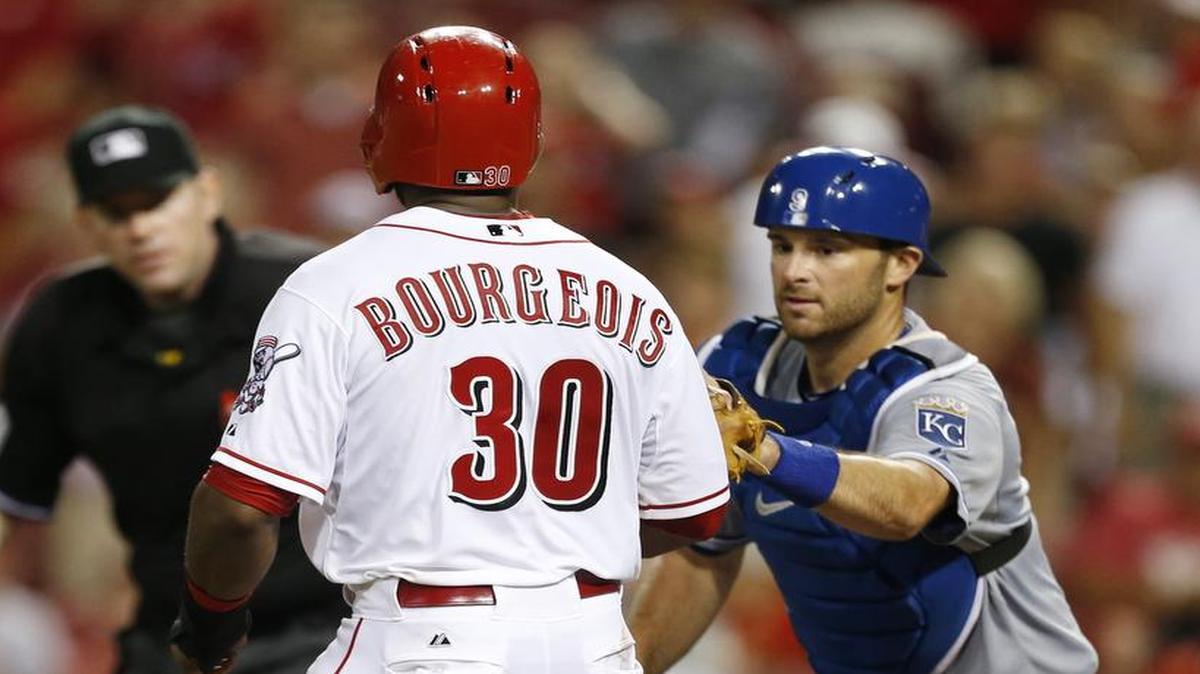 
Cincinnati Reds center fielder Jason Bourgeois was tagged out at home plate by Kansas City Royals catcher Drew Butera for the second out of a double play.
