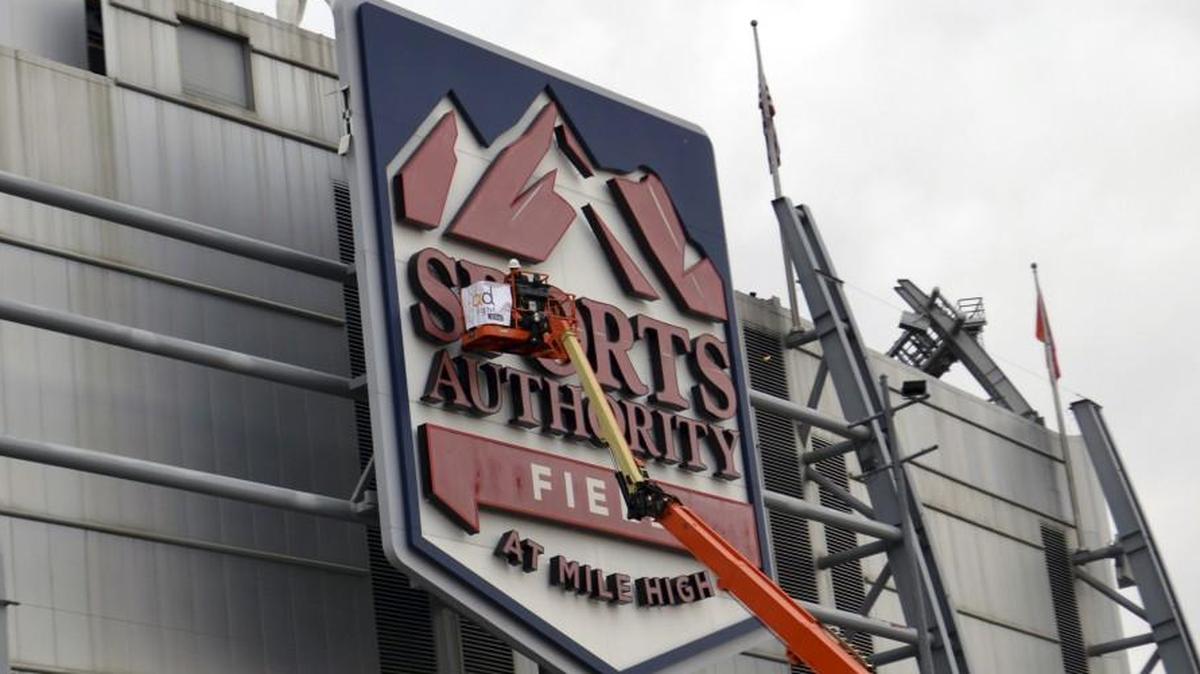 Workers begin disconnecting the Sports Authority Field at Mile High sign at the stadium for the Denver Broncos.