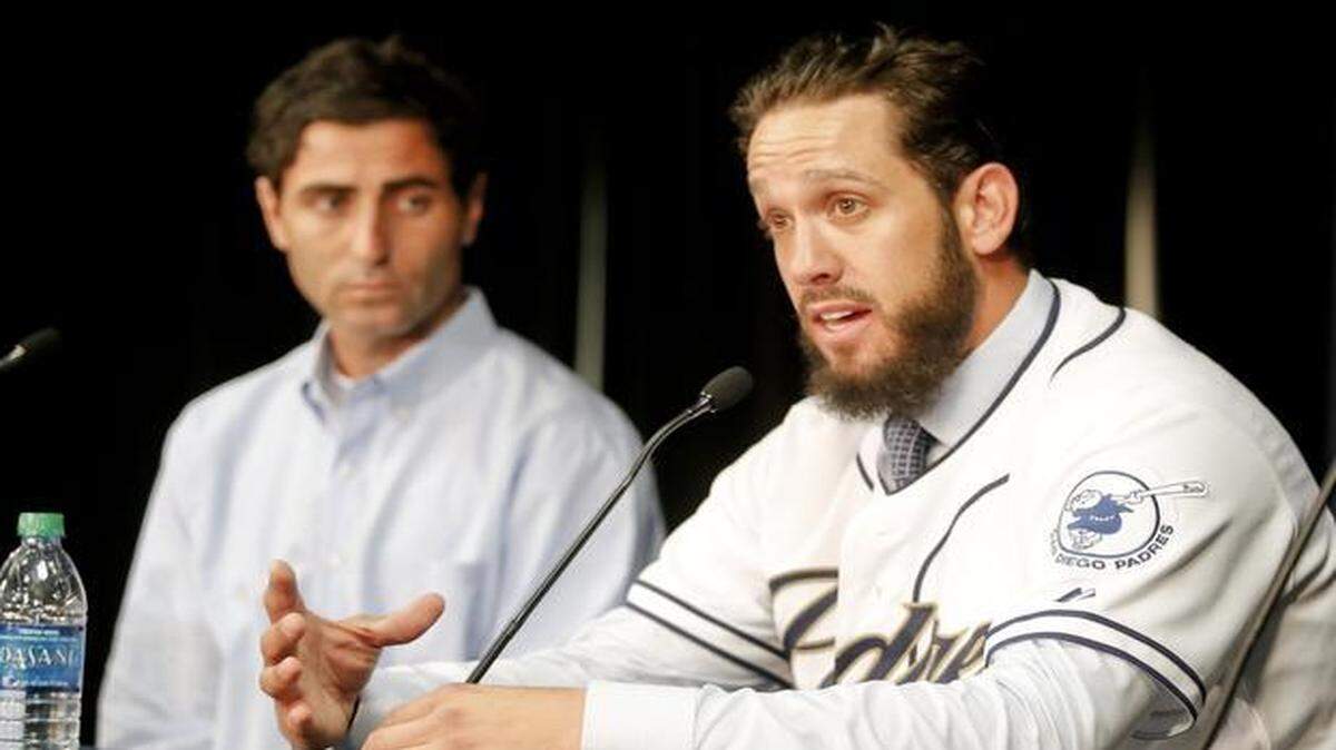 
James Shields answered questions after signing a four-year contract with the Padres in San Diego. General manager A.J. Preller listens. 
