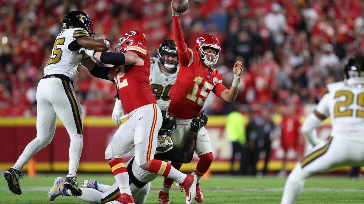 Chiefs quarterback Patrick Mahomes throws a pass as he's hit by Cameron Jordan #94 of the New Orleans Saints during the third quarter at GEHA Field at Arrowhead Stadium on Oct. 7, 2024 in Kansas City, Missouri.