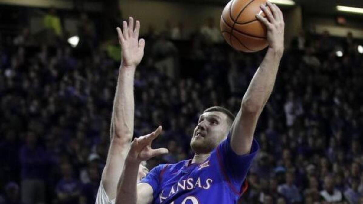 Kansas guard Sviatoslav Mykhailiuk drove for a basket against Kansas State forward Dean Wade during Monday’s game.