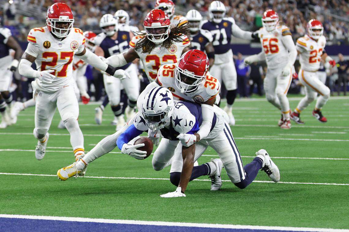 George Pickens of the Dallas Cowboys is tackled after his reception by Jaylen Watson of the Kansas City Chiefs during the fourth quarter in the game at AT&T Stadium on Nov. 27, 2025 in Arlington, Texas.