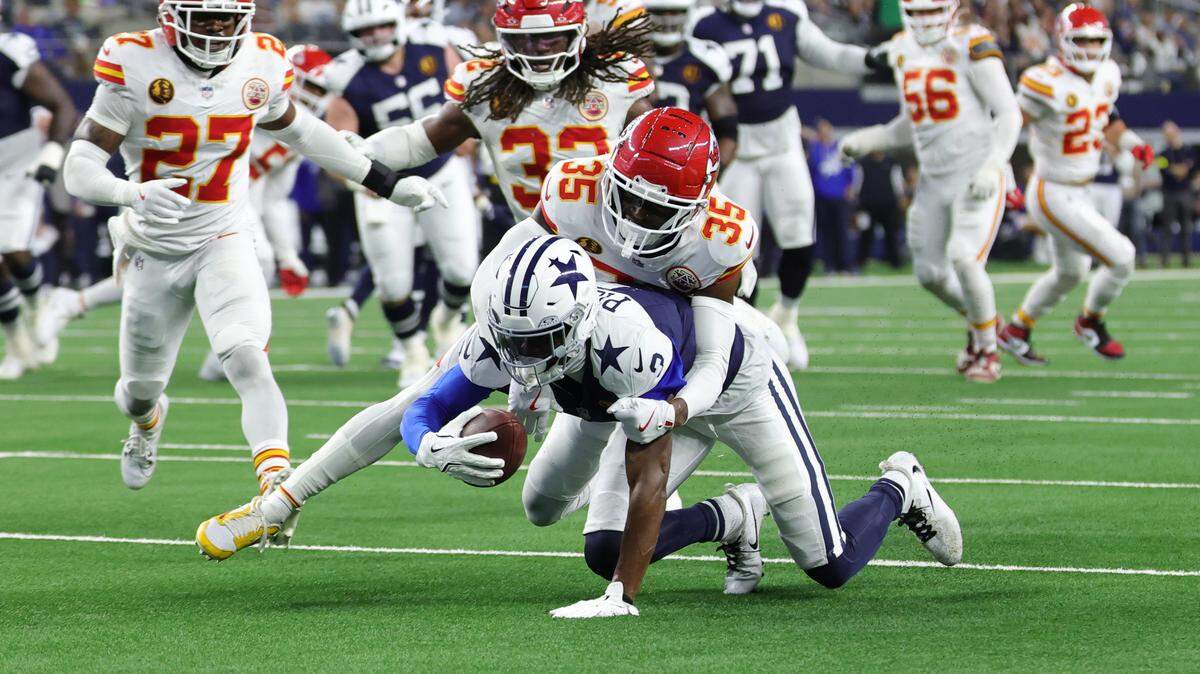 George Pickens of the Dallas Cowboys is tackled after his reception by Jaylen Watson of the Kansas City Chiefs during the fourth quarter in the game at AT&T Stadium on Nov. 27, 2025 in Arlington, Texas.
