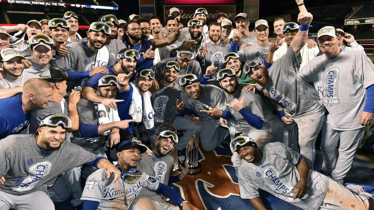 The Kansas City Royals likely weren’t thinking about playoff shares when they posed for this photo. But they each got a nice big check for winning that trophy.