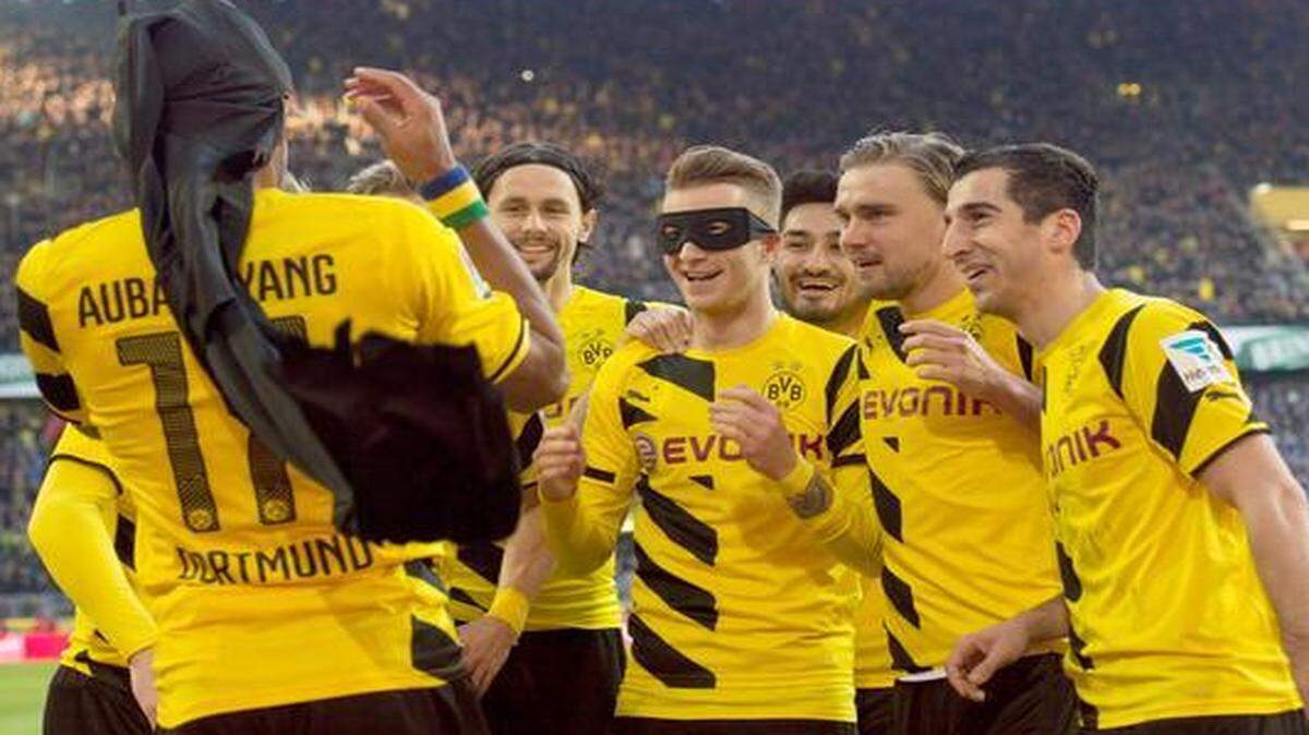 
In this Saturday Feb. 28, 2015 picture Dortmund’s Marco Reus, dressed as Robin and Pierre-Emerick Aubameyang (left) dressed as Batman as they celebrated a goal.
