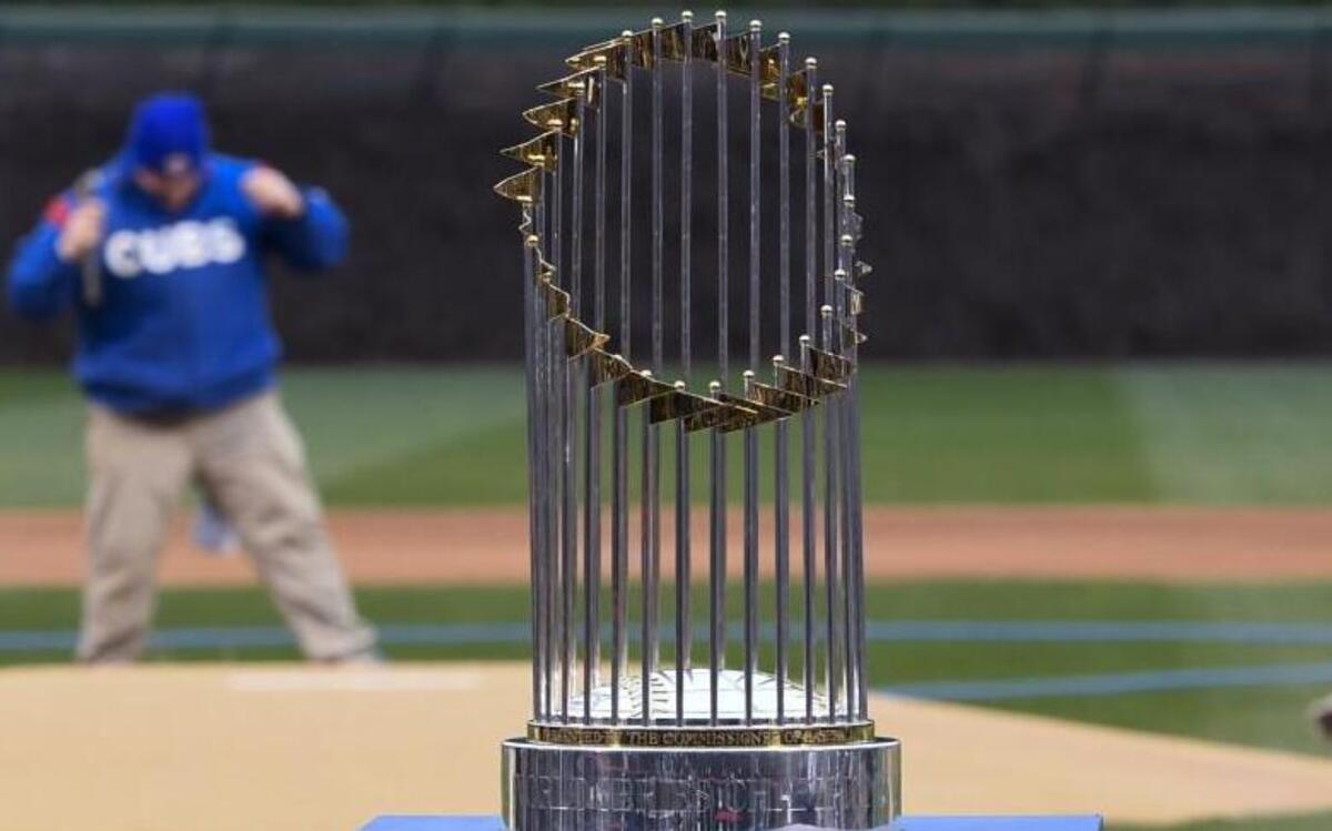 Chicago Cubs grounds crew members prepared the field near the Commissioner’s Trophy as the team prepared to celebrate during the 2016 World Series championship ring ceremony before the Cubs’ game against the Los Angeles Dodgers on April 12, 2017, in Chicago.