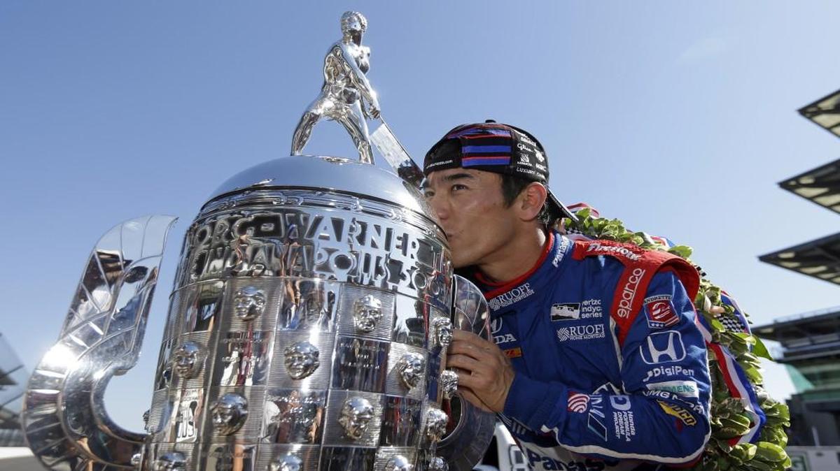 Indianapolis 500 champion Takuma Sato kissed the Borg-Warner Trophy during the traditional winners photo session on the start/finish line at the Indianapolis Motor Speedway.