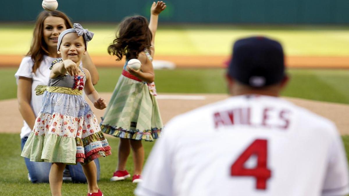 
Cleveland’s Mike Aviles caught the ceremonial first pitch from his daughter Adriana as his wife, Jessy, watched prior to the Indians’ game against the New York Yankees on Thursday.
