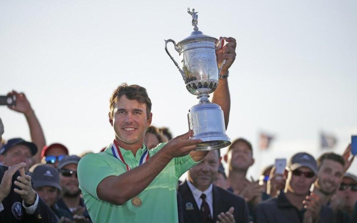 Brooks Koepka held up the U.S. Open Championship trophy at Erin Hills in Hartford, Wis.