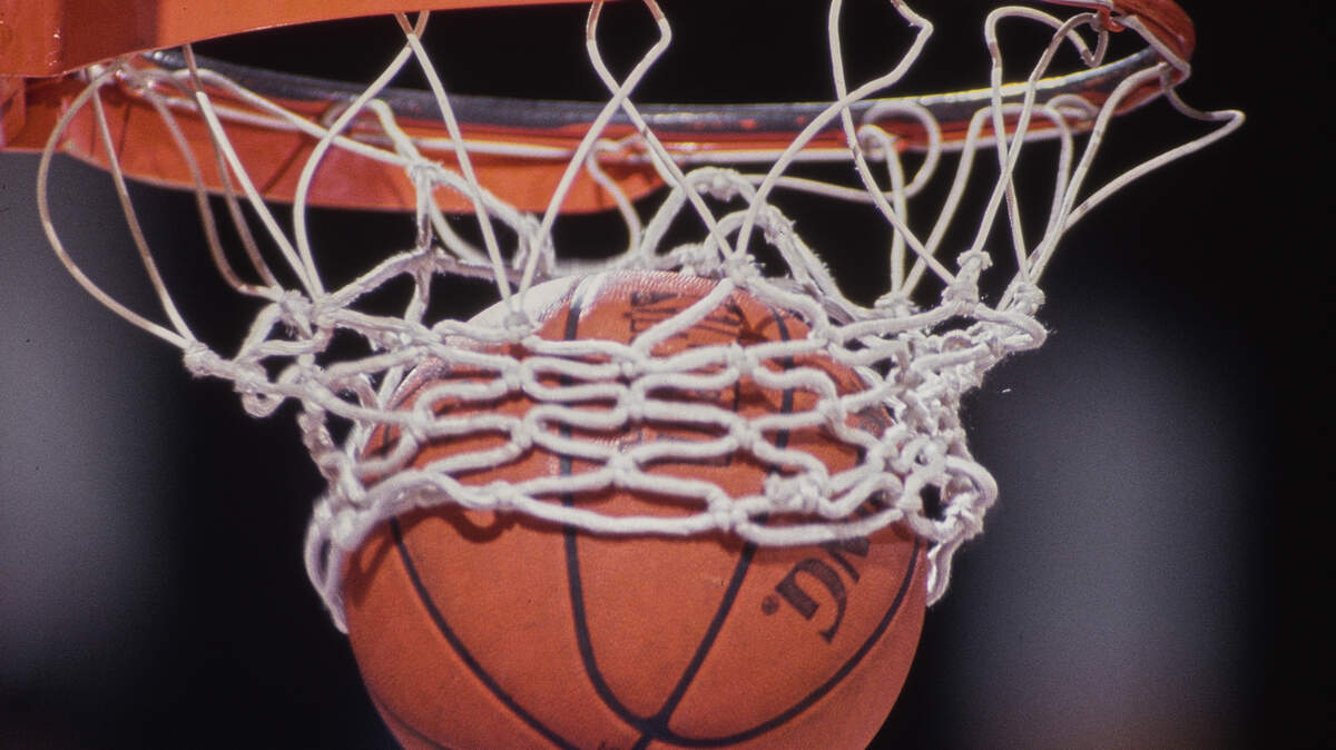 General detail view of a basketball dropping into the hoop.