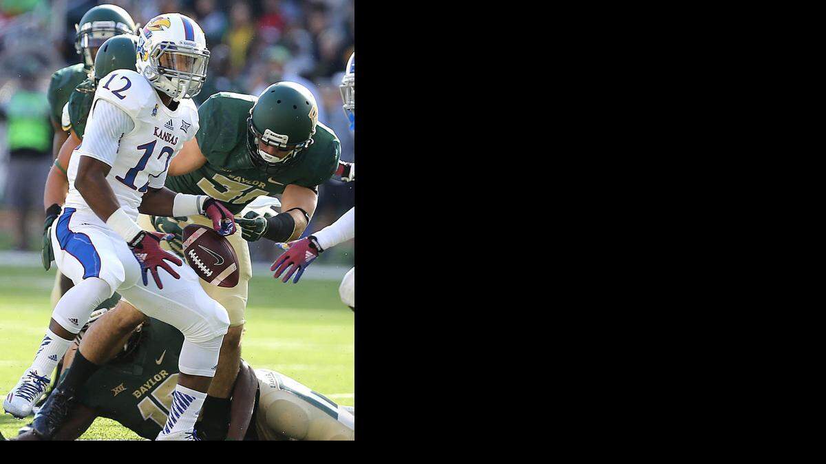 
Kansas wide receiver Darious Crawley lost the ball as he was hit by Baylor’s Nacita Silas during a game last year.
