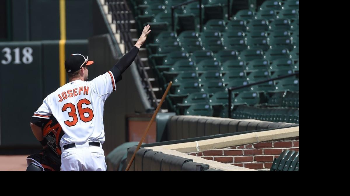
Orioles catcher Caleb Joseph waves to imaginary to fans April 29 in Baltimore in a game where fans were not permitted to attend
