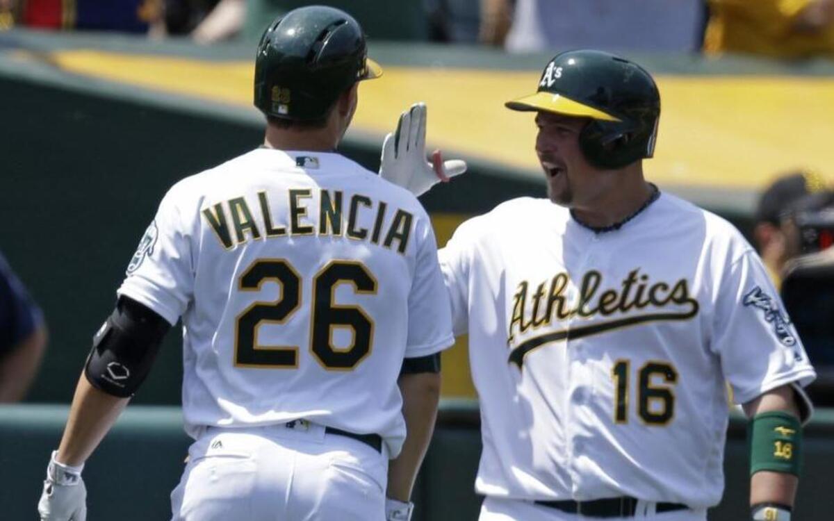 In this May 28, 2016 file photo Oakland’s Danny Valencia was congratulated by Billy Butler after hitting a home run.