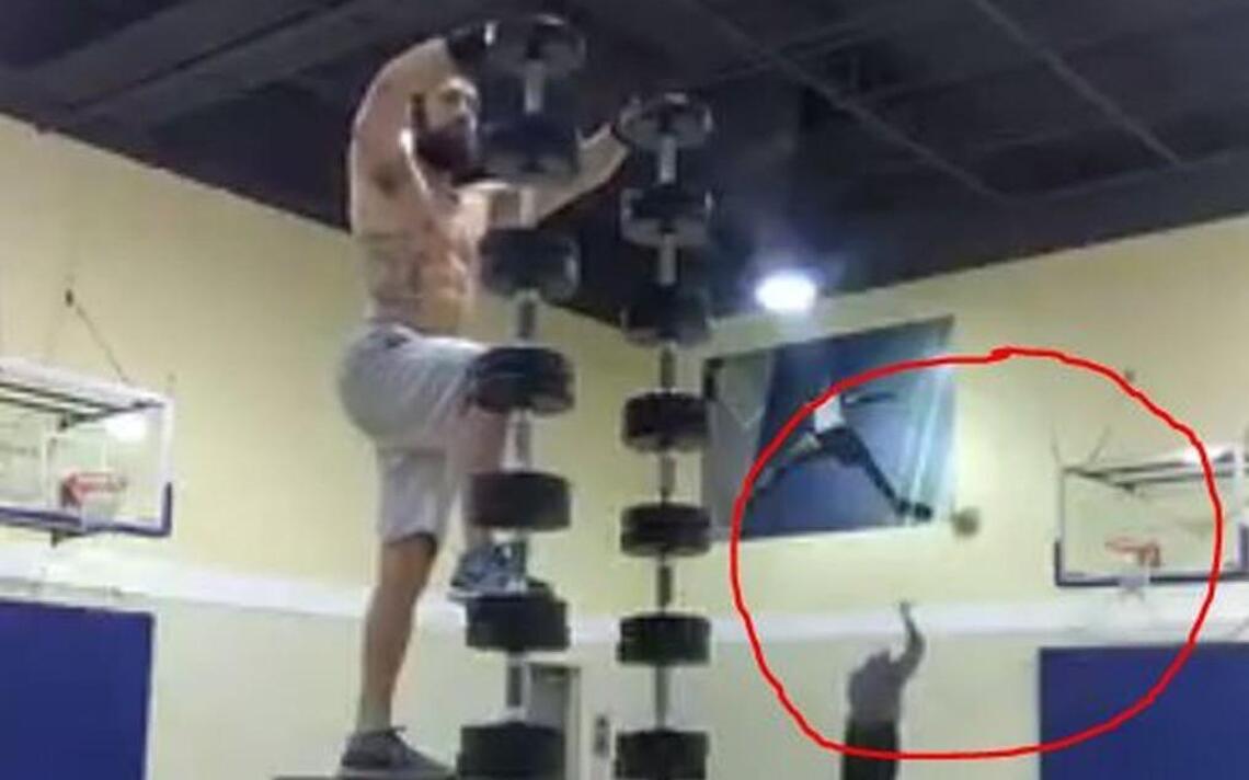 Video of guy doing epic handstand on weights overshadowed by old man shooting baskets