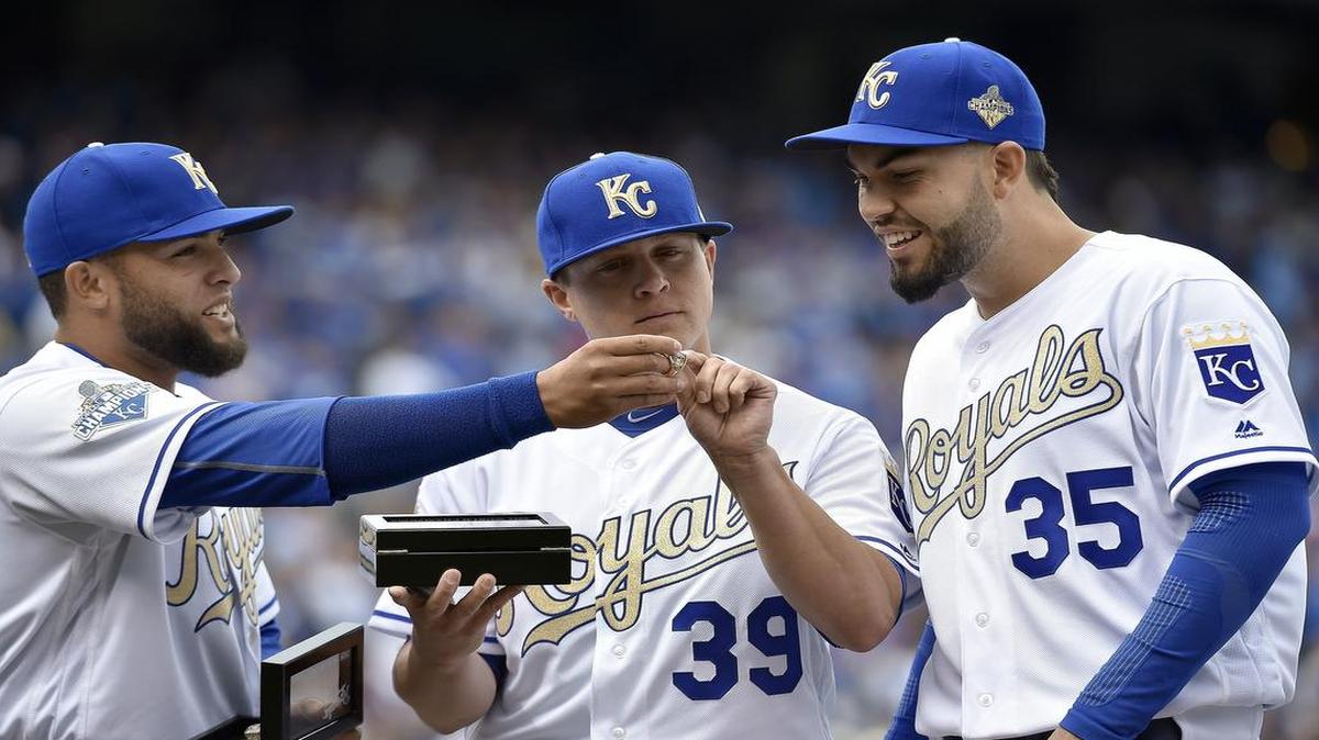 Kansas City Royals players Kelvin Herrera, Kris Medlen and Eric Hosmer look at the inscription inside their 2015 World Series rings before an April 5, 2016 game against the Mets at Kauffman Stadium in Kansas City, Mo.