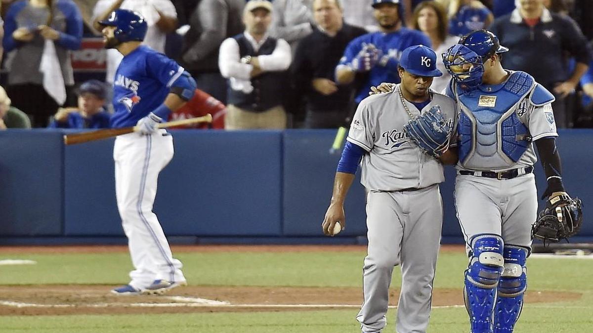 Royals catcher Salvador Perez (right) attempts to keep starting pitcher Edinson Volquez focused via a visit to the mound during Jose Bautista’s game-changing at-bat in the sixth inning of Game 5.