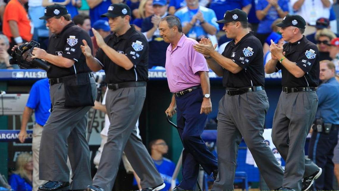 Former umpire Steve Palermo, center in pink shirt, walked off the field after being honored in pre-game ceremonies during Tuesday's All-Star Game on July 10, 2012, at Kauffman Stadium in Kansas City, Mo.