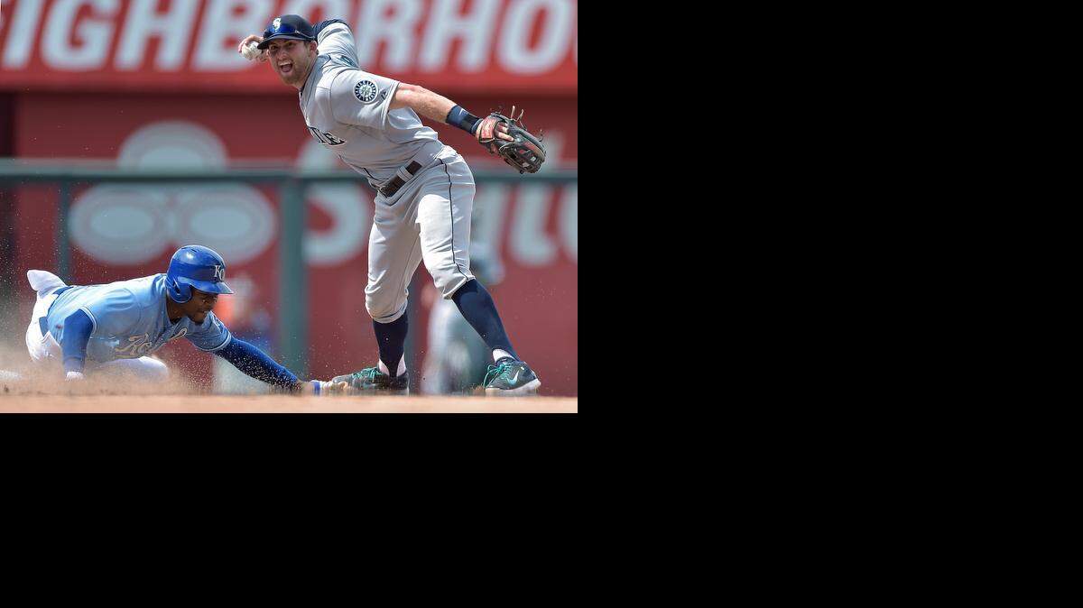 
Mariners shortstop Brad Miller forced out the Royals’ Jarrod Dyson at second and threw to first to complete the double play in the ninth inning of Saturday’s game at Kauffman Stadium.
