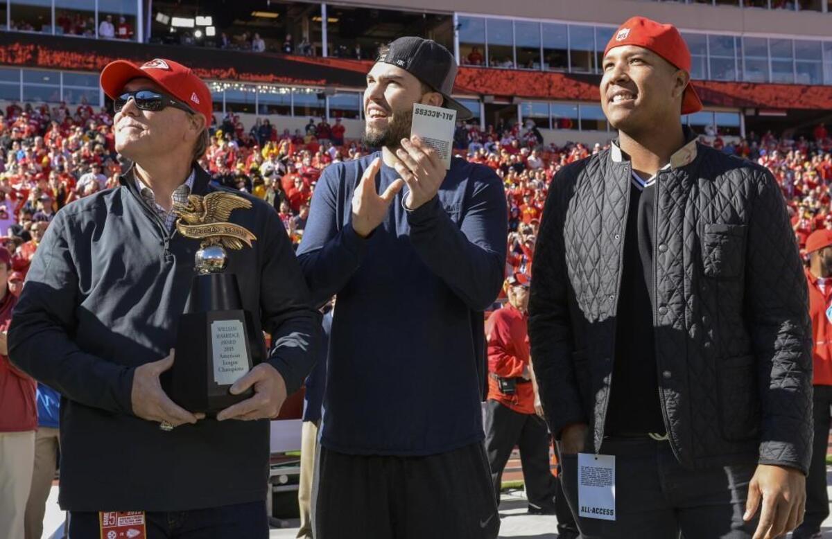 Eric Hosmer, center, with Royals manager Ned Yost and teammate Salvy Perez, did much to improve relations between the two tenants at the Truman Sports Complex, going to Chiefs games and forging friendships with Chiefs players.