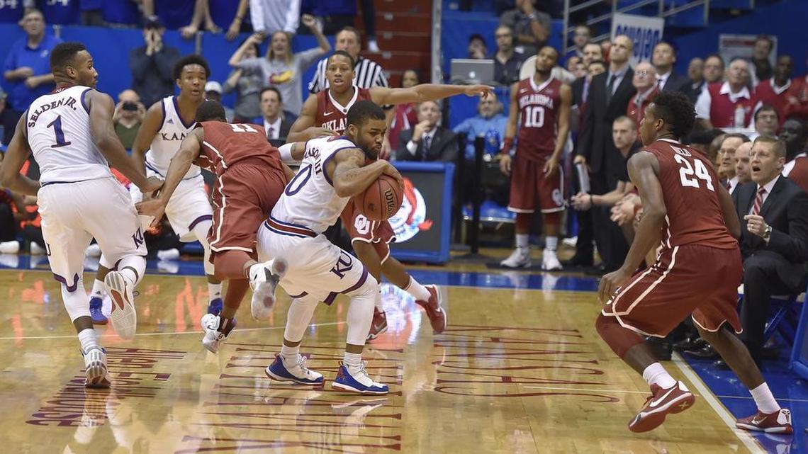 KU's Frank Mason (middle) beat OU's Isaiah Cousins to a loose ball after the Sooners Buddy Hield (right) threw a bad inbounds pass, sealing the 109-106 triple overtime win for the Jayhawks Monday night at Allen Fieldhouse.