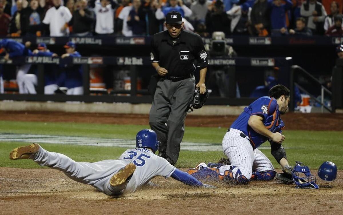 Home plate umpire Alfonso Marquez watches as Eric Hosmer scores during Game 5 of the Royals’ 2015 World Series victory over the Mets in New York.
