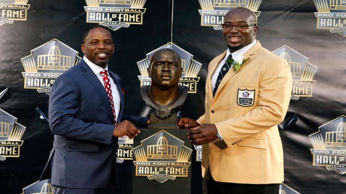
Former Chiefs offensive guard Will Shields (right) posed with his Pro Football Hall of Fame bust and with presenter and friend Adrian Lunsford on Saturday in Canton, Ohio.

