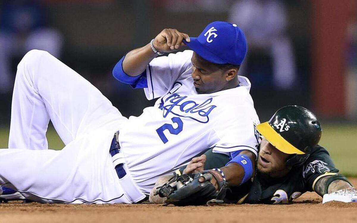 
Kansas City Royals shortstop Alcides Escobar (2) ends up on top of Oakland Athletics’ Brett Lawrie (15) after forcing him out at second in seventh inning before Escobar exited the game at Kauffman Stadium in Kansas City, Mo.
