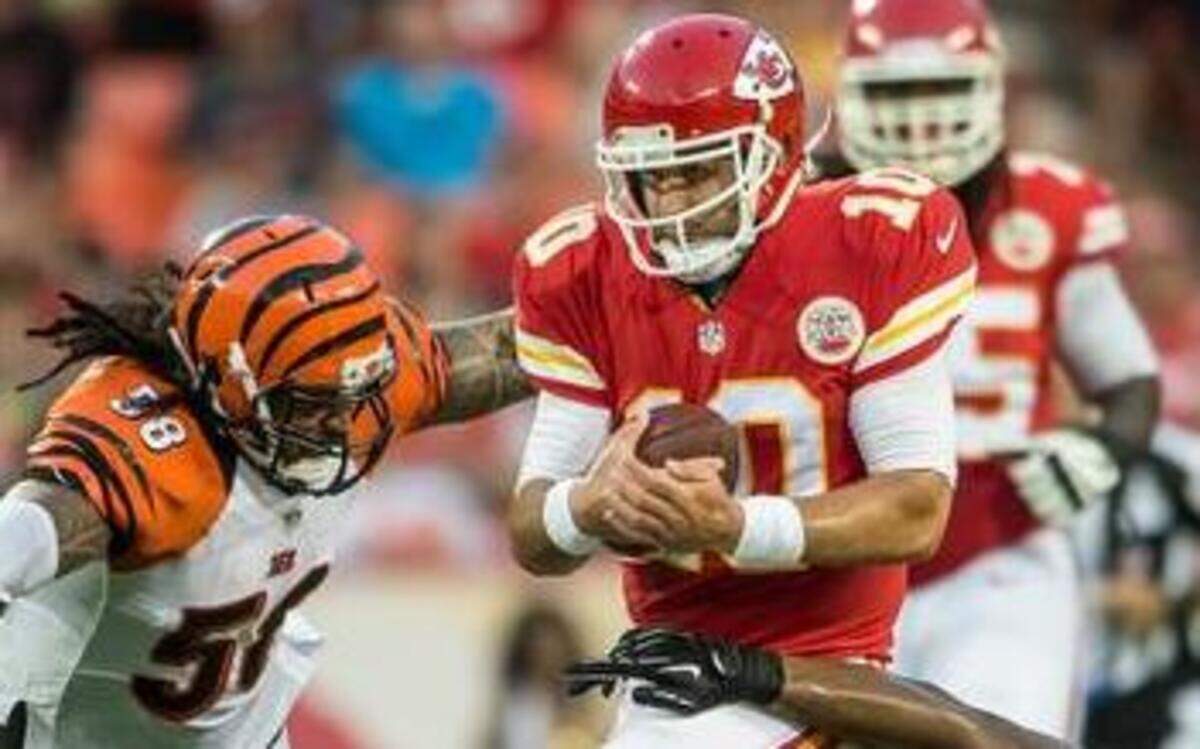 
Kansas City Chiefs quarterback Chase Daniel (10) scrambled for a run in the second quarter before being tackled by Cincinnati Bengals middle linebacker Rey Maualuga (58) and Cincinnati Bengals middle linebacker Vincent Rey (57) in the NFL preseason opener on August 7, 2014 at Arrowhead Stadium in Kansas City, Mo.
