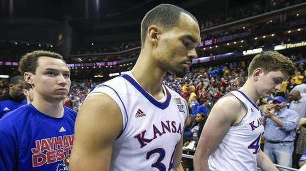 
Kansas forward Perry Ellis (center) and his teammates walked off the court after their 70-66 loss to Iowa State on Saturday at the Big 12 Tournament at the Sprint Center. 
