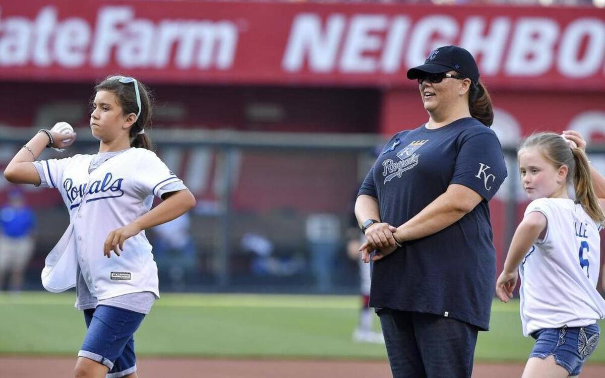 Jamie Lancaster (center) widow of Kansas City, Kansas police detective Brad Lancaster, who was killed in the line of duty May 9, watched daughters Bri (left) and Jillian throw out first pitches before a July 18 baseball game between the Kansas City Royals and Cleveland Indians at Kauffman Stadium.