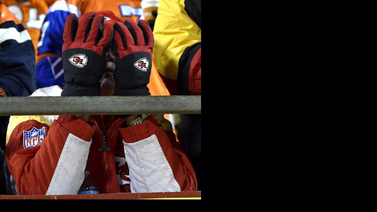
A Kansas City Chiefs fan covers his face while watching the Kansas City Chiefs and Denver Broncos football game at Arrowhead Stadium on Sunday, November 30, 2014, in Kansas City, Mo..
