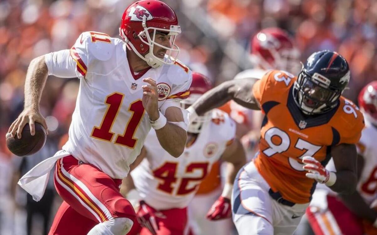 
Kansas City Chiefs quarterback Alex Smith (11) scrambled away from Denver Broncos defensive end Quanterus Smith during a game last year.
