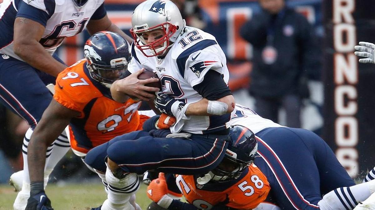 New England Patriots quarterback Tom Brady was sacked by Denver Broncos outside linebacker Von Miller (bottom) and Malik Jackson during the second half of Sunday’s AFC Championship Game.
