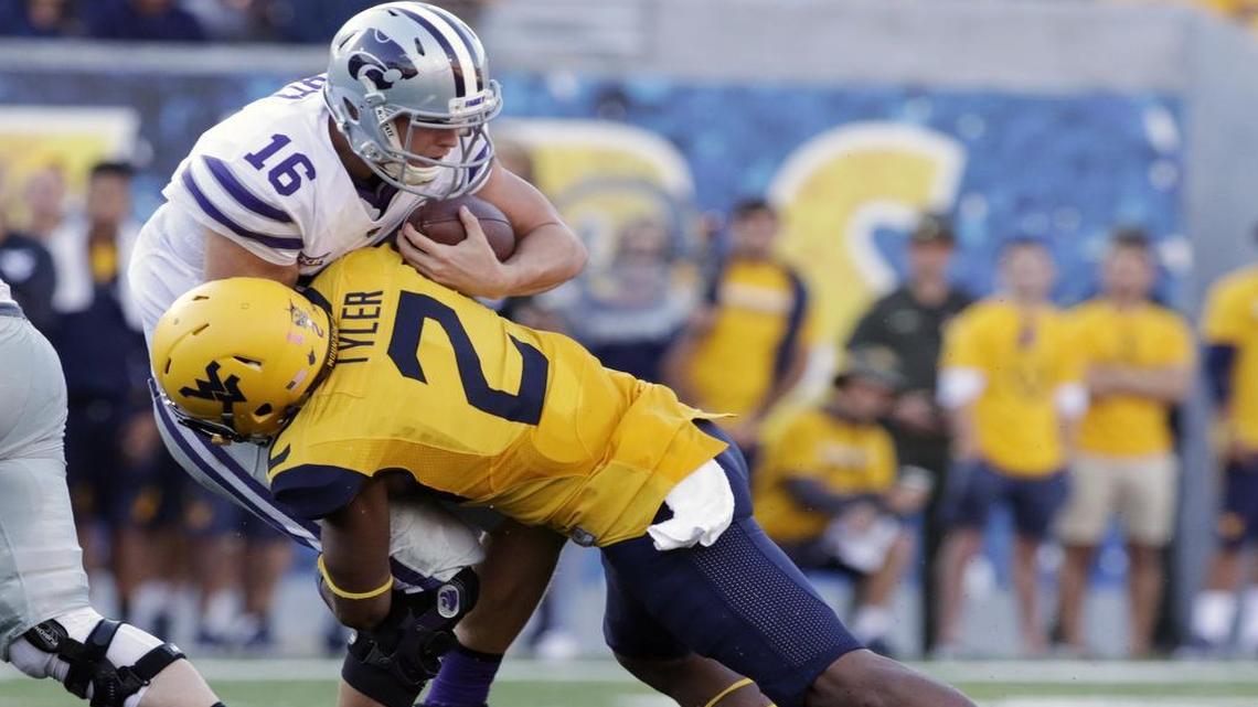 Kansas State quarterback Jesse Ertz was taken down by West Virginia safety Jeremy Tyler in the second half of Saturday’s game in Morgantown, W.Va.